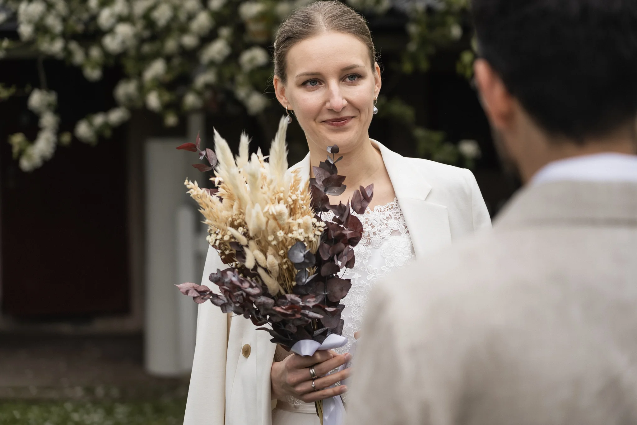 Bruden med sin bukett under ceremonin Bruden med bukett under vigseln utomhus i Malmö – bröllopsfotograf Malmö